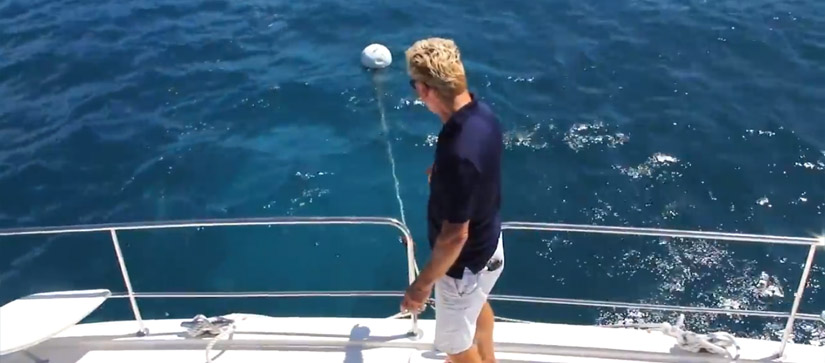 Man explaining how to pick up a mooring ball
