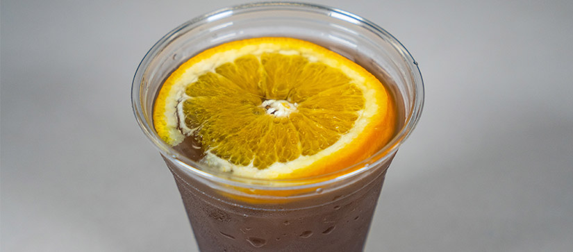 purple drink in a cup with an orange