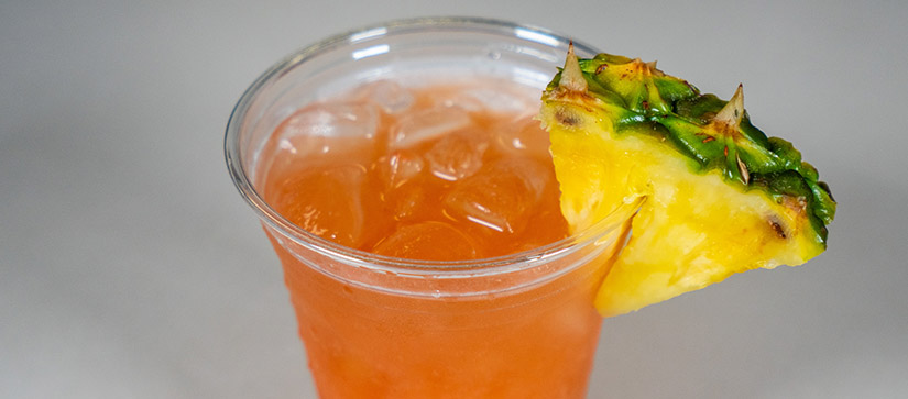 orange drink in a cup with a pineapple