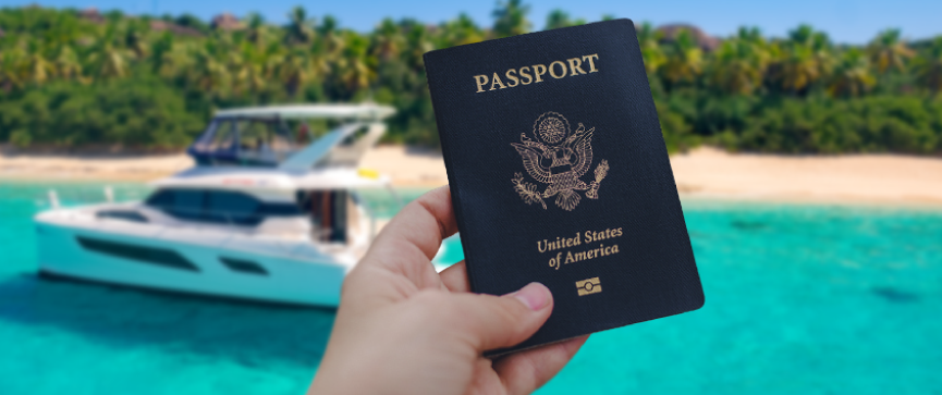 Person holding passport with a charter boat in the background