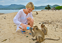 woman sharing water with monkeys in leeward islands