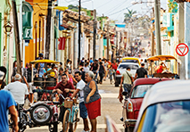 crowded street with people cars and buildings