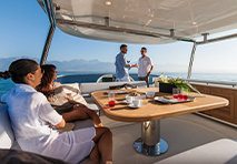 group of people sitting around table on yacht