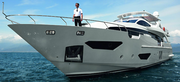 Man standing aboard yacht on water