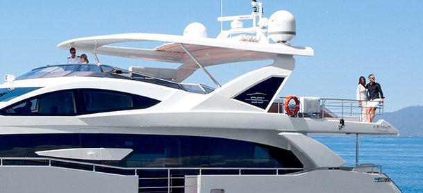 Couple enjoying the view from back of yacht