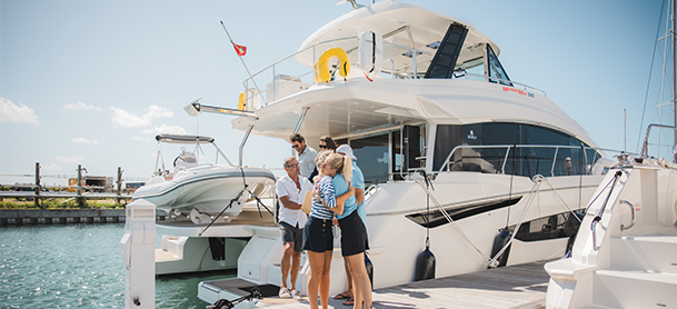 charter customers and crew hugging in front of MarineMax 545 charter