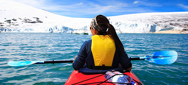 Woman kayaking in Alaska waters.