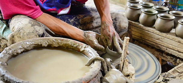 A close-up shot of a person working with pottery