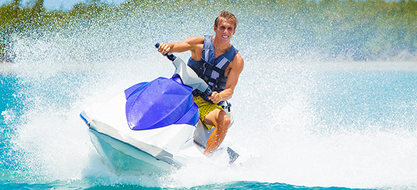 A man turns a jetski and creates a wave