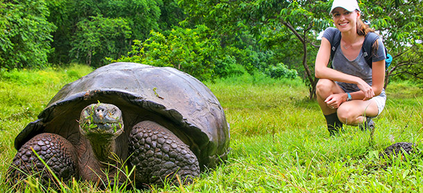 Woman near giant tortoise