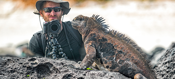 Man photographing iguana