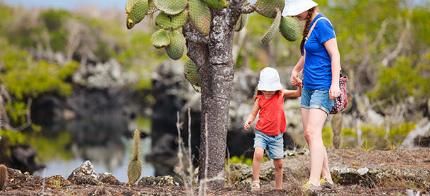 Woman and child walking together near trees