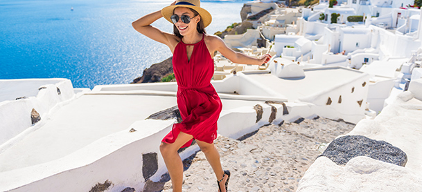 Woman in red dress running along a brick pathway