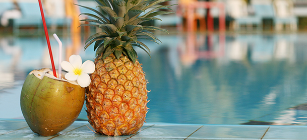 Coconut drink next to pineapple