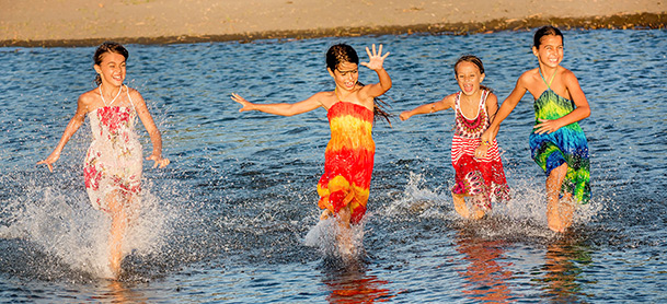 Kids dressed up running in water