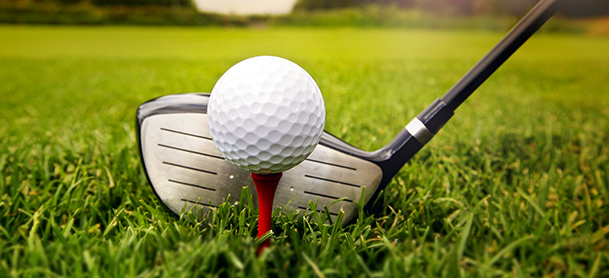 Teed golf ball and driver