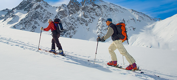People cross country skiing in mountain range