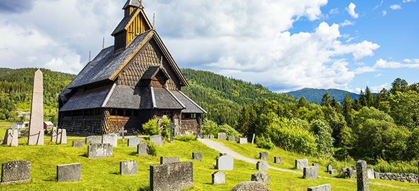 Church among gravestones on green hills