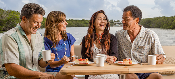 Two couples enjoying dessert and coffee