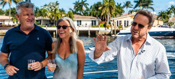 Four people hanging out on the side of the yacht