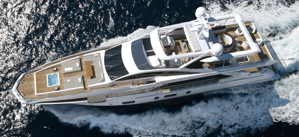 An aerial view of a yacht cruising from right to left