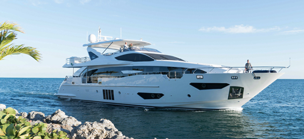 A yacht cruises through the water from left to right