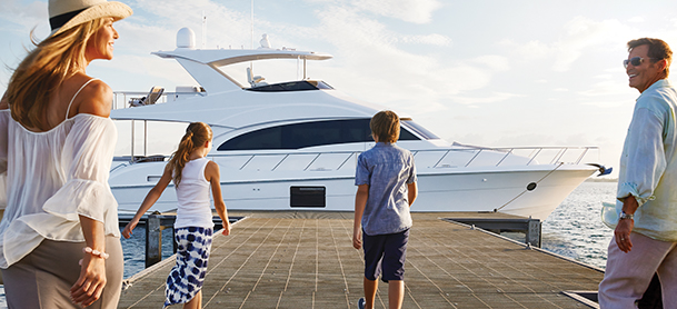Family walking on dock towards yacht