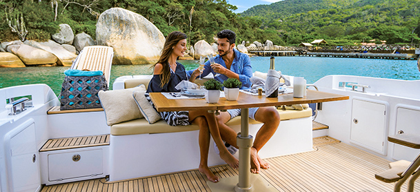 couple sitting at table on the aft deck of a yacht