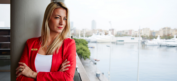 professional woman with arms crossed overlooking water