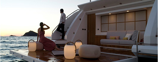 man and women on swim platform of large azimut yacht