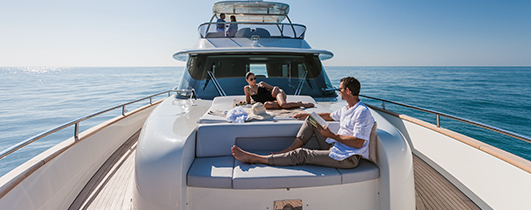 a couple sitting on an azimut yacht deck