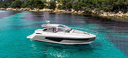 an azimut yacht anchored in blue waters close to an island