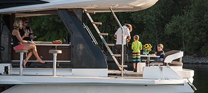 group of adult and children relaxing in a yacht lounge area