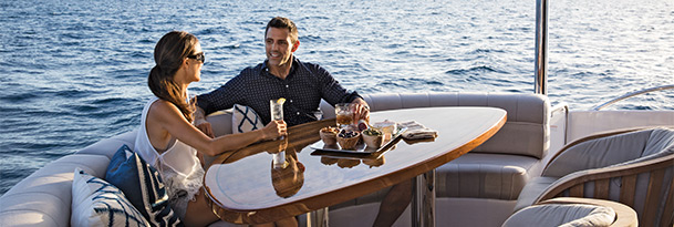 couple sitting at table on hatteras yacht