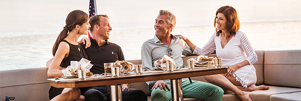 couples sitting on aft seating area of sea ray