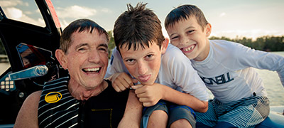man and two kids wearing life jackets