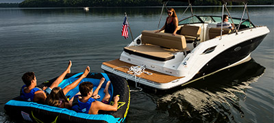 family on tube being towed by tender