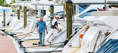several boats and yachts lined up along dock