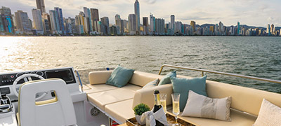 open deck of a yacht with city skyline in background