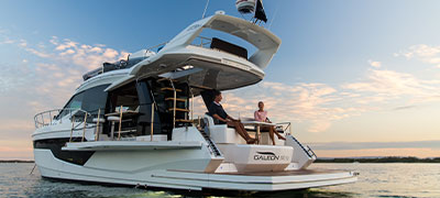 Galeon Yacht model in the water with two people aboard