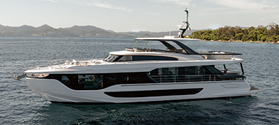 Sleek white yacht cruising on calm blue sea with distant green hills and a clear sky, conveying luxury and tranquility.