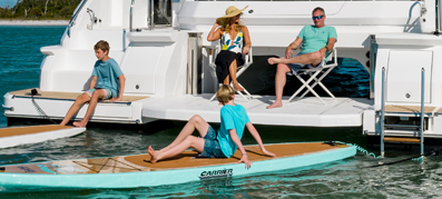 family on a MarineMax charter with paddle boards 