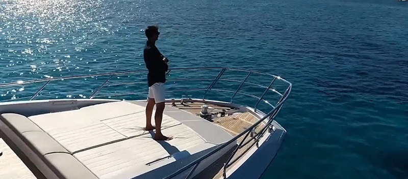 A man standing on the bow of a yacht