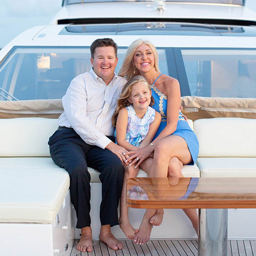 a man and woman sitting on a boat with their daughter sitting between them
