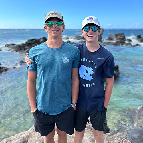 a man and a boy look off the edge of a boat