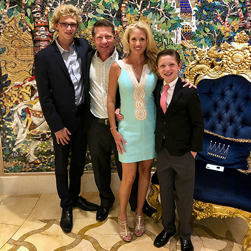 a family of a husband and wife with two boys